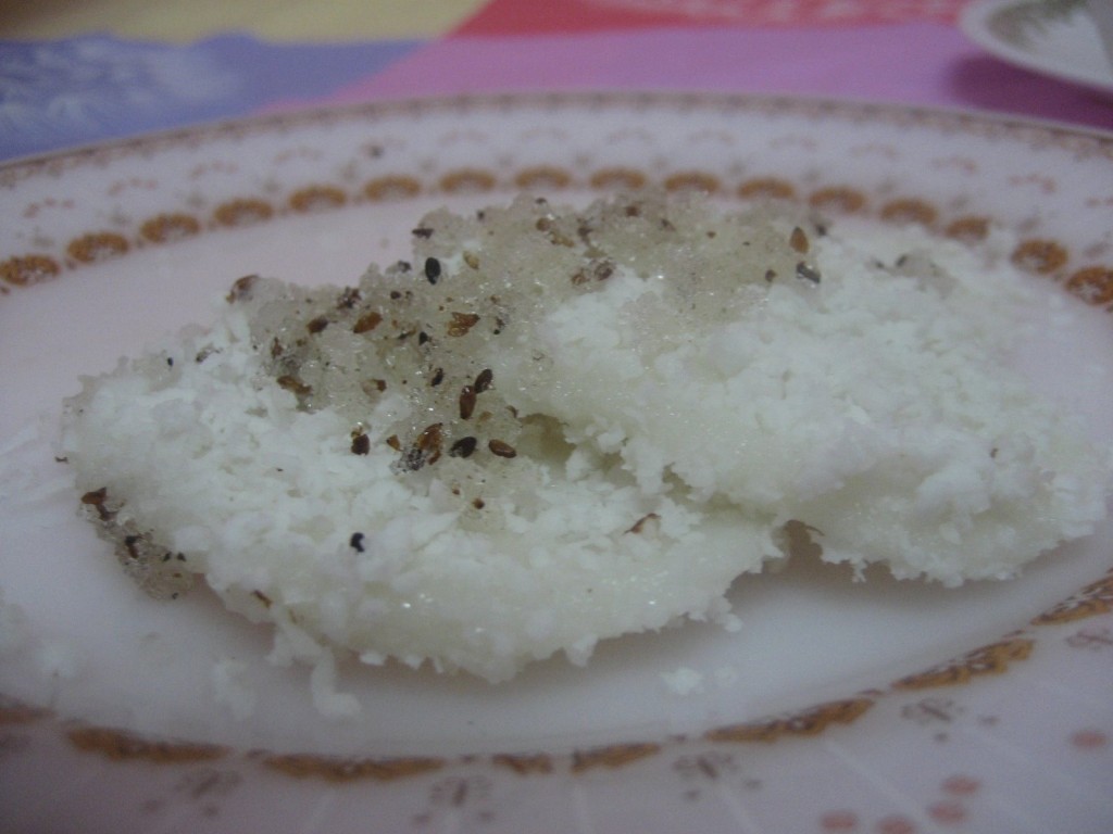 Palitaw topped with sugar and toasted sesame seeds